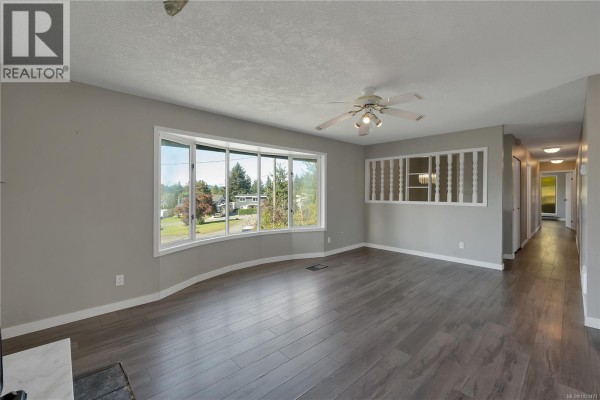 Kitchen with stainless steel appliances, dark wood cabinets, and light countertops. - 531 Savary Cres, Campbell River