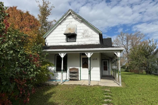 Kitchen with white appliances, white cabinets, a stove, a refrigerator, and washer and dryer. - 535 Curwen Street, Cartwright