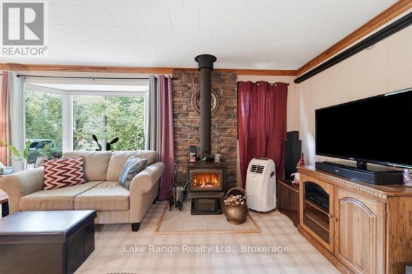 Living room with wood-burning stove and bay window - 536 Alfred Street Huron Kinloss