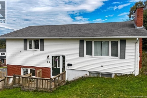 Front exterior of a white split-level house with grey shutters and a red brick base. - 54-56 Northumberland Avenue, Saint John