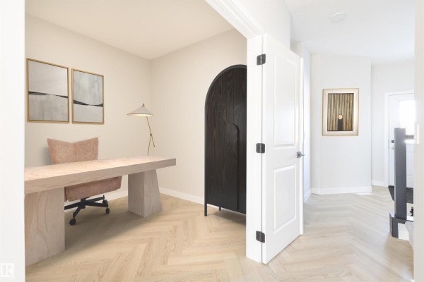 Home office with a light wood desk, upholstered chair, minimalist artwork, and herringbone wood floors. - 54 Cuddie Dr, Sherwood Park