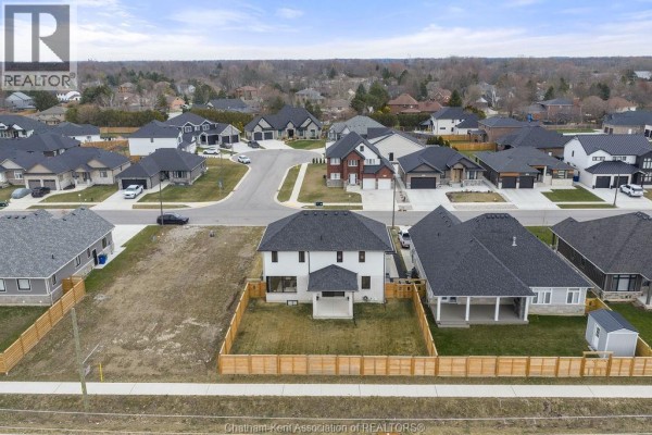 Modern homes with attached garages and covered porches - 54 Dundee Drive West Chatham
