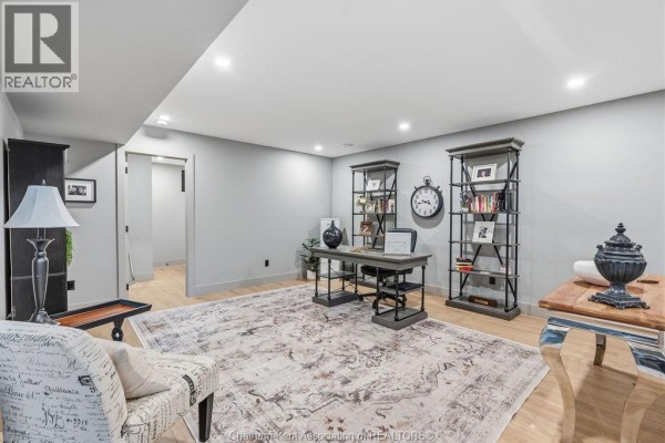 Office with desk, bookshelves, rug, and clock - 54 Dundee Drive West Chatham