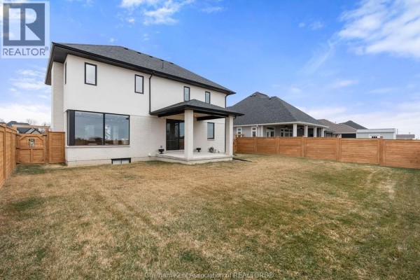 Modern two-story house with large corner window and covered porch - 54 Dundee Drive West Chatham