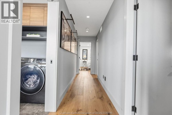 Washer/dryer and hardwood floors in hallway - 54 Dundee Drive West Chatham