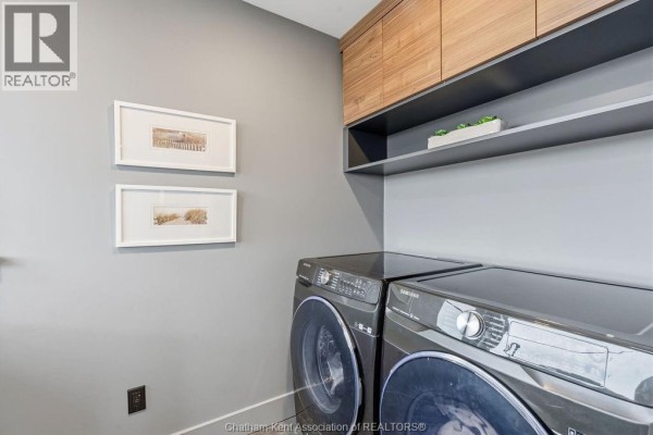 Modern laundry room with Samsung washers, wood cabinets, and shelves - 54 Dundee Drive West Chatham