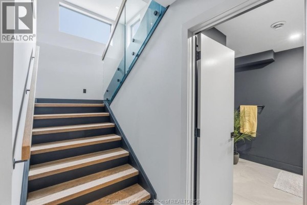 Modern staircase with glass railing and wood treads - 54 Dundee Drive West Chatham