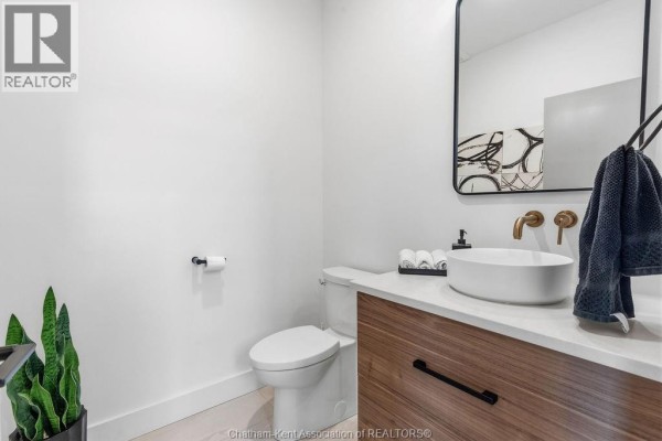 Vessel sink, gold faucets, and modern vanity - 54 Dundee Drive West Chatham