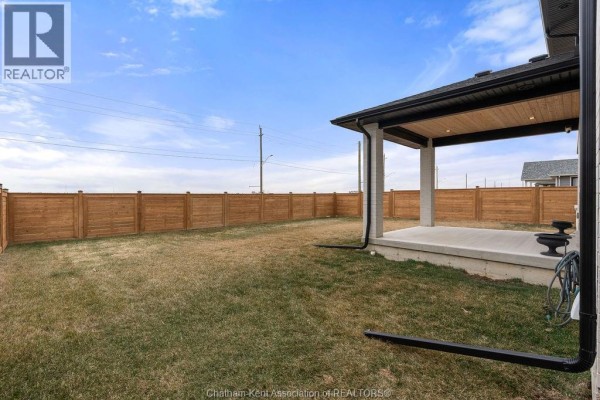 Covered patio and fenced yard with outdoor lighting - 54 Dundee Drive West Chatham