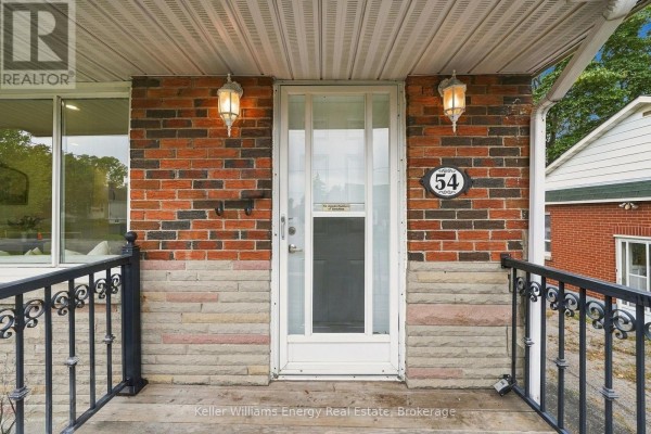 Close-up of the front door and porch with brick and stone details. - 54 Eastlawn Street, Oshawa