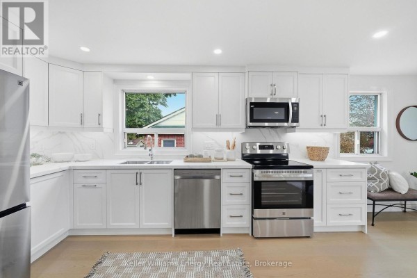 Bright white kitchen with quartz countertops and stainless steel appliances. - 54 Eastlawn Street, Oshawa