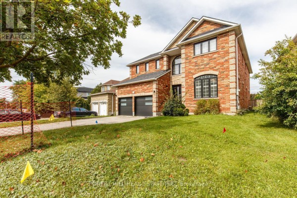 Side view of a red brick house with a manicured lawn and visible fence. - 54 Maple Grove Avenue, Richmond Hill