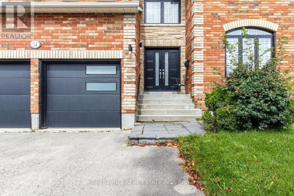 Close-up of the double garage doors, front entrance with double doors, and stone steps. - 54 Maple Grove Avenue, Richmond Hill