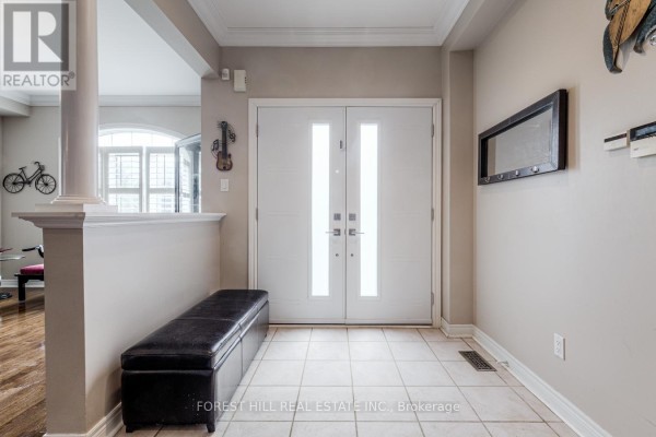 Interior foyer with beige walls, tiled floor, a black bench, and double front doors. - 54 Maple Grove Avenue, Richmond Hill