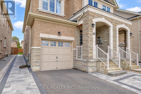 Side view of a brick house at 54 Mohandas Drive showing the garage door and front entrance steps. - 54 Mohandas Drive, Markham