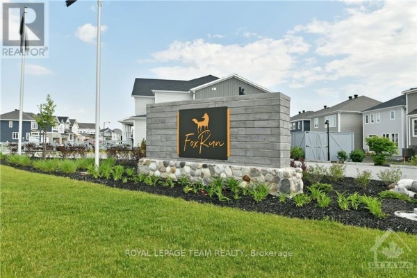 Entrance sign for "Fox Run" development with stone base and metal lettering. - 54 Reynard Crescent, Ottawa