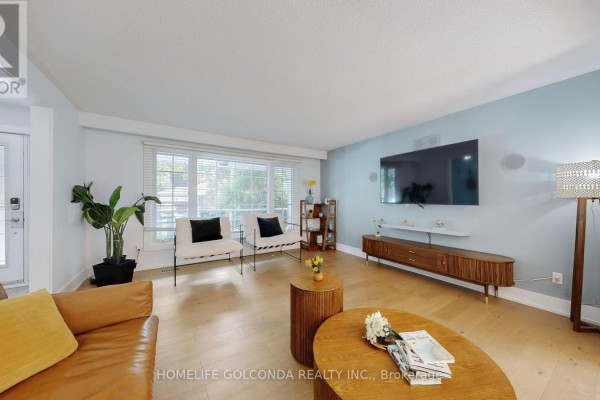 Living room with a blue accent wall and modern entertainment unit - 54 Senator Reesor's Drive, Markham