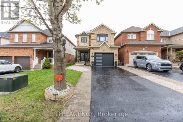 Front exterior of a brick house with a modern garage door and paved driveway. - 54 Thames Drive, Whitby