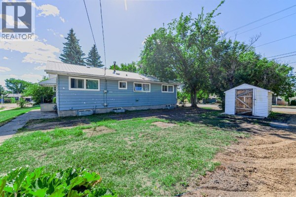 Detailed view of kitchen with appliances, wooden flooring, and ample counter space. - 5402 52 Street, Bashaw
