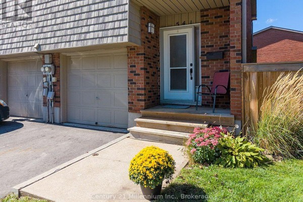Close-up of the entrance to a townhouse at 541 Tenth Street, showing a front door and two garages. - 541 Tenth Street, Collingwood