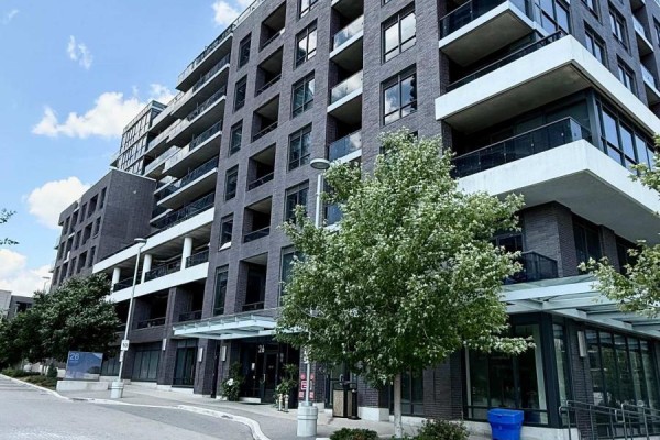 Exterior of the modern apartment building with dark brick facade and balconies. - 543 - 26 Gibbs Road, Toronto