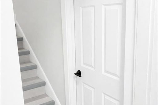 Interior hallway with a door and stairs leading to the upper level - 543-545 Saint Anne Street, Bathurst