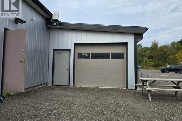 Another view of the building's garage door and an entry door. - 543 Greenwich Street Unit# 4, Brantford