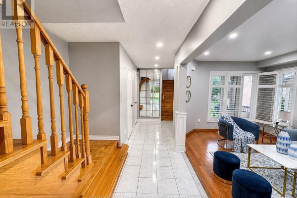 Entrance hallway with wooden stairs and tiled floors, opening to living room - 5456 Palmerston Crescent Mississauga
