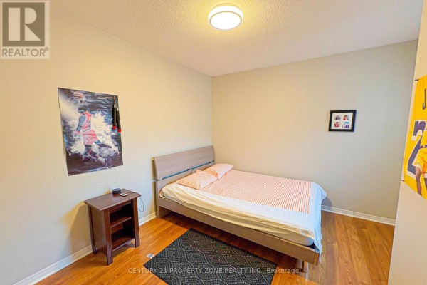 Bedroom with bed, nightstand, and basketball posters - 5456 Palmerston Crescent Mississauga
