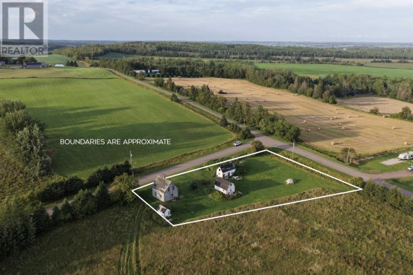 Rural landscape with two barns and a weathered house under a clear blue sky. - 547 New Argyle Road, New Argyle