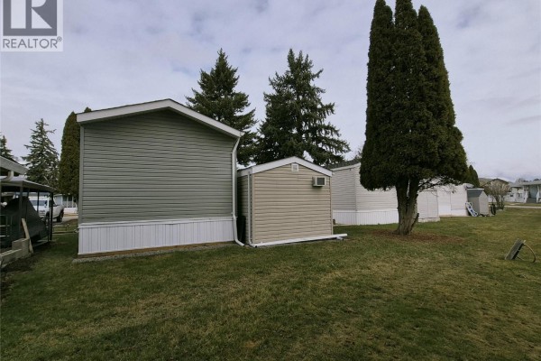 Backyard view highlighting the home's exterior and adjacent structures - 5484 Okanagan Landing Road Unit# 51, Vernon