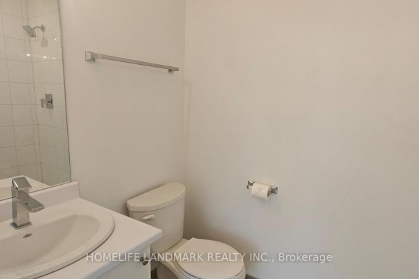 Bathroom featuring a sink, toilet, and tiled shower area. - 5494 Main Street, Whitchurch Stouffville