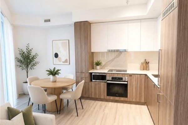 Contemporary kitchen with light wood cabinets, white uppers, and dining area. - 55 Cooper Street Unit# 6008, Toronto