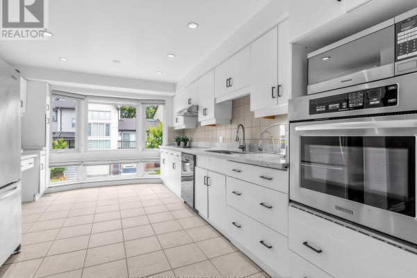 Interior entryway with a white door, beige tile floor, and pale green walls. - 55 English Ivyway, Toronto