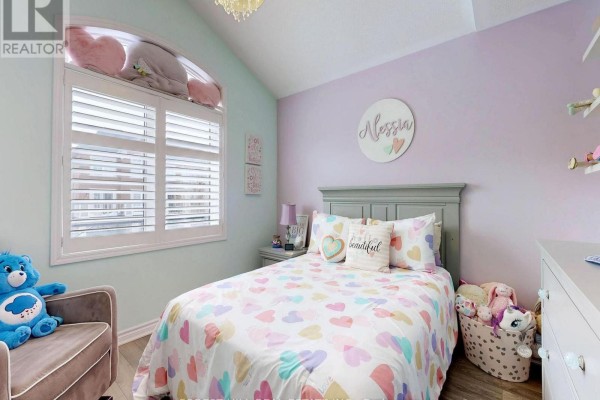 Child's bedroom with heart comforter, armchair, and arched window - 55 Stocks Lane Aurora