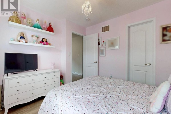 Bedroom with dresser, TV, shelves of dolls, chandelier - 55 Stocks Lane Aurora