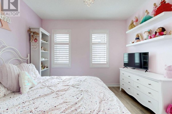 Bedroom with white bed, dresser, TV, shelves, and chandelier - 55 Stocks Lane Aurora