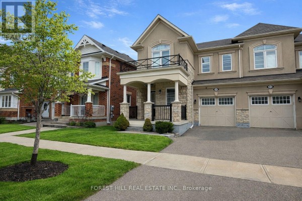 Exterior of a modern home with a two-car garage, balcony, and stone accents - 55 Stocks Lane Aurora