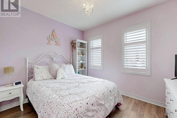 Bedroom with pink walls, white bed, shutters, and chandelier - 55 Stocks Lane Aurora