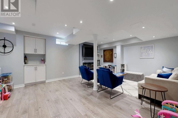 Living room with sofa, blue armchairs, fireplace, and built-in cabinets - 55 Stocks Lane Aurora