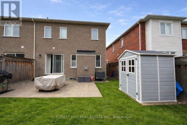 Backyard with patio, storage shed, and lawn - 55 Stocks Lane Aurora