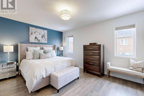 King bed, mirrored nightstands, dresser, storage bench, blue accent wall - 55 Stocks Lane Aurora