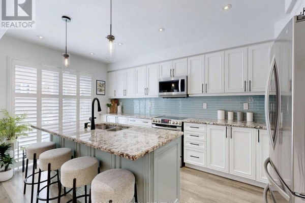 Kitchen with island, granite counters, subway tile backsplash, and stainless steel appliances - 55 Stocks Lane Aurora