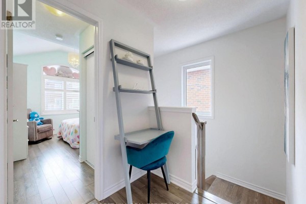 Hallway landing with ladder desk and teal chair - 55 Stocks Lane Aurora