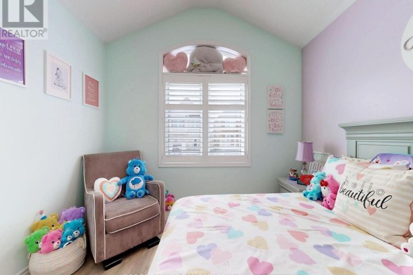 Bedroom with heart bedding, plush toys, and arched window - 55 Stocks Lane Aurora