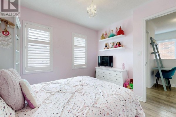 Bedroom with bed, dresser, TV, and shelves with dolls - 55 Stocks Lane Aurora