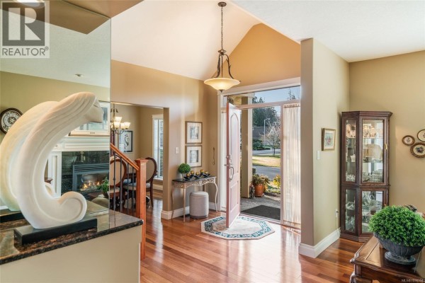 Kitchen with light wood cabinets, granite countertops, and a circular dining table. - 550 Falcon Crt, Parksville