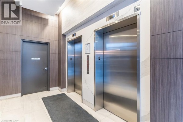 Elevator area featuring two stainless steel elevators and a clean, modern design - 550 North Service Road Unit# 516, Grimsby