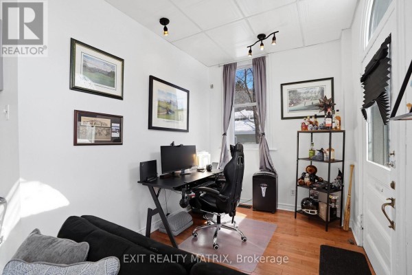 Compact kitchen with white cabinets, white stove, light countertop, and a small beverage fridge. - 5505 Osgoode Main Street, Ottawa