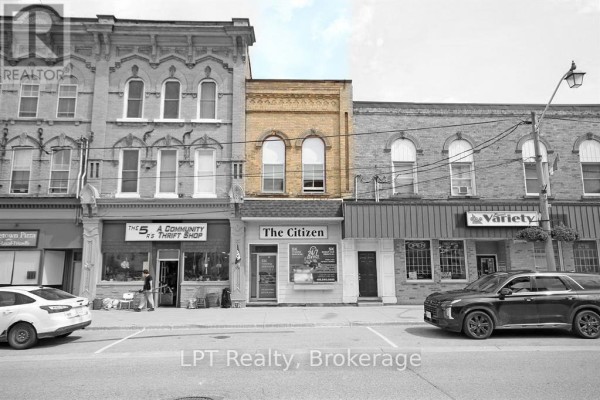 Street view of two-story brick buildings with storefronts including "The Citizen" and "Variety". - 551 Turnberry Street, Huron East